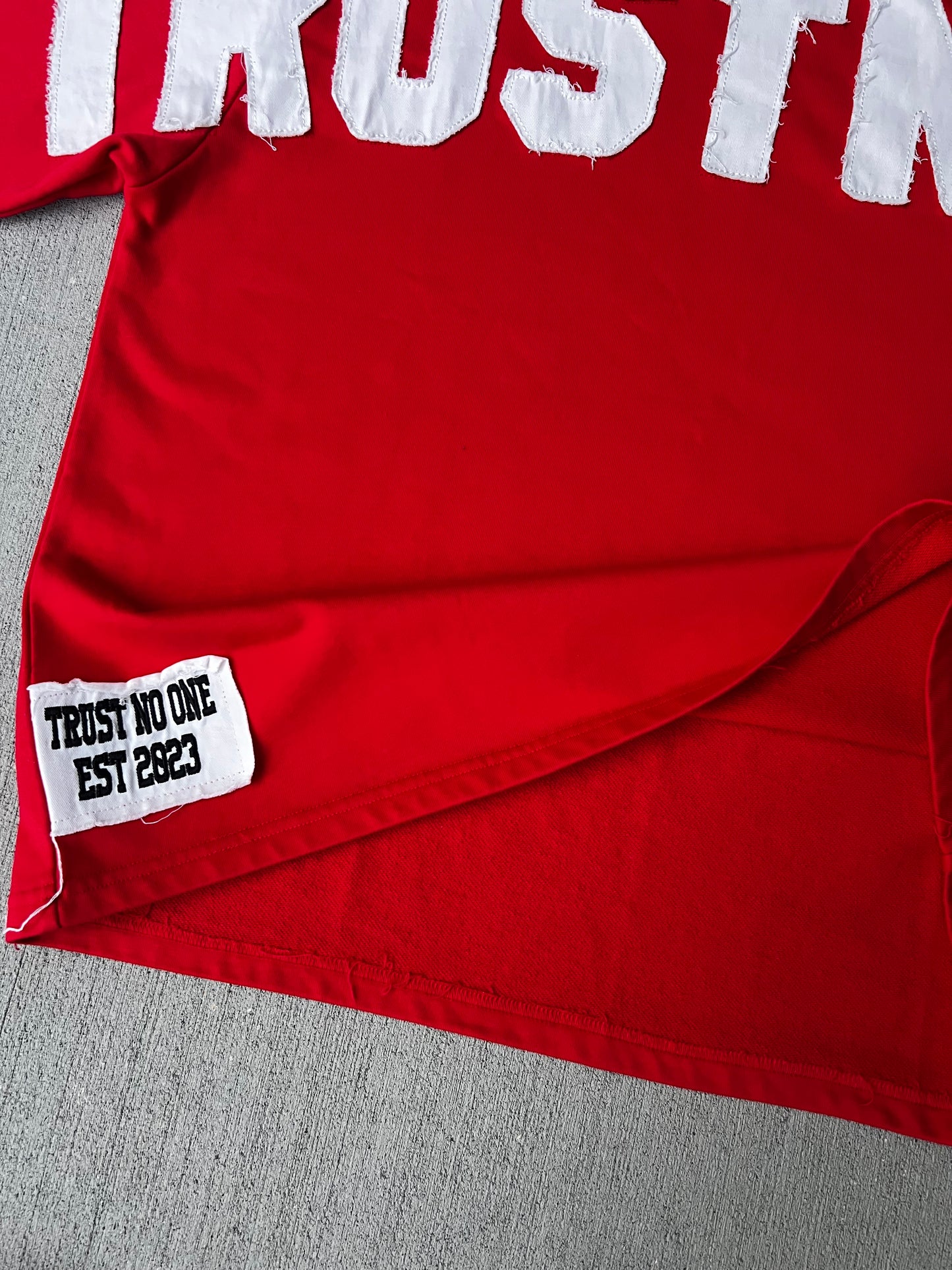 “Trustnone” Red distressed Oversized Tee